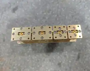 What is the working principle of the end - launch waveguide to coaxial adapter?
